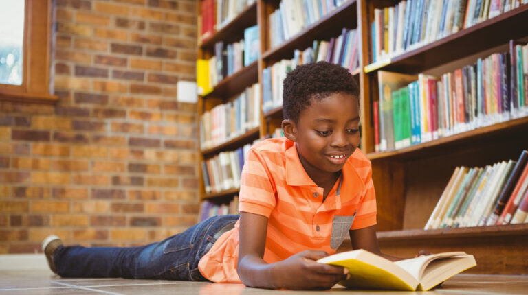 Cute,Little,Boy,Reading,Book,In,The,Library